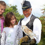 A girl holding a barn owl at Mary Arden's Farm, Warwickshire