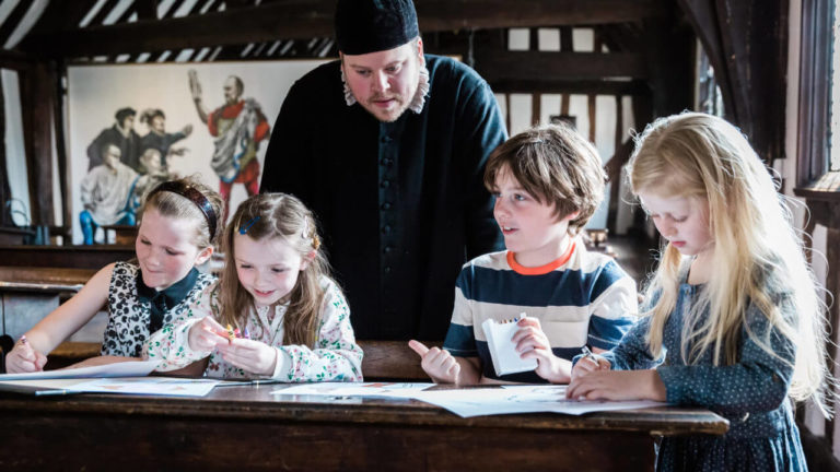 Master and children at Shakespeare's Schoolroom in Stratford-upon-Avon